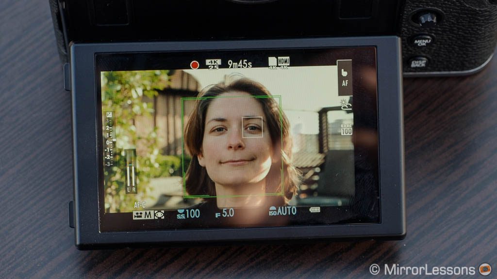 lcd screen of the X-T30 showing face and eye detection at work on the face of a woman
