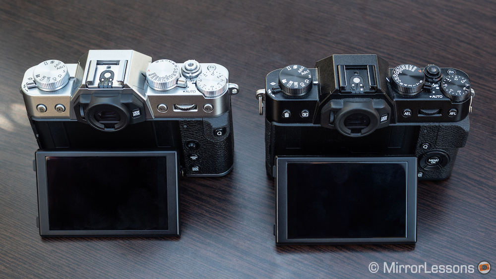 Fujifilm X-T20 next to the X-T30, rear angled view with LCD screen titled up