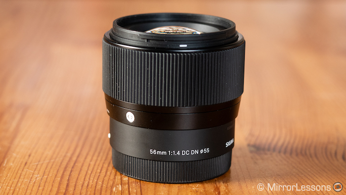 sigma 56mm 1.4 without hood on a wooden table