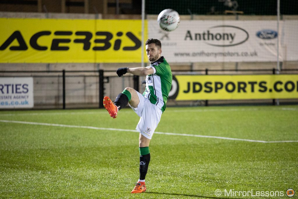 football player kicking the ball