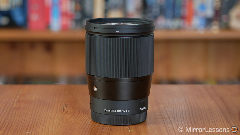 Sigma 16mm f1.4 standing on a wooden table