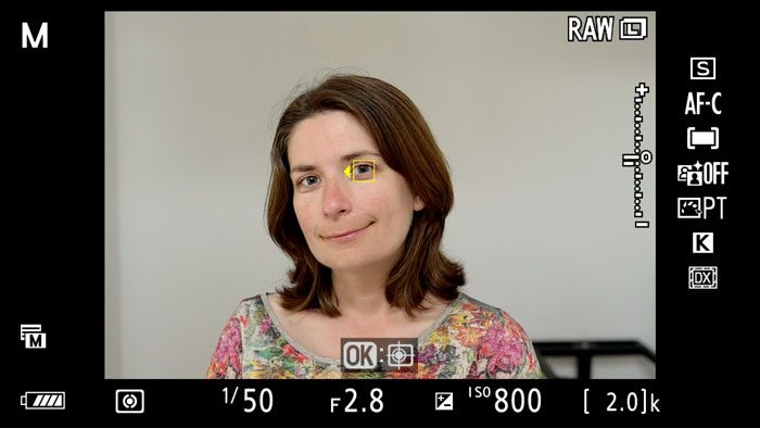 screenshot of the Nikon Z6 live view, showing Eye AF at works on the face of a woman