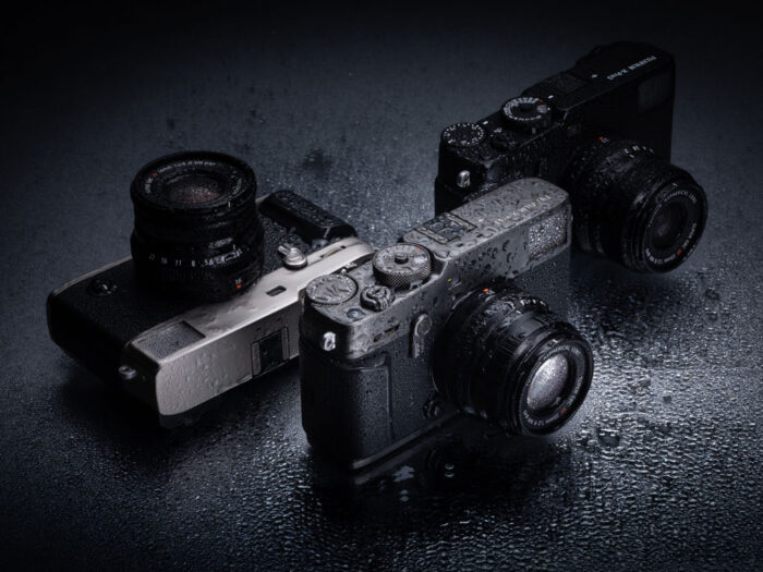 Three X-Pro3 cameras covered in water droplets
