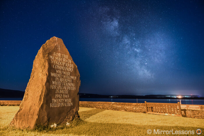 stone monument in the foreground and milky way in the background