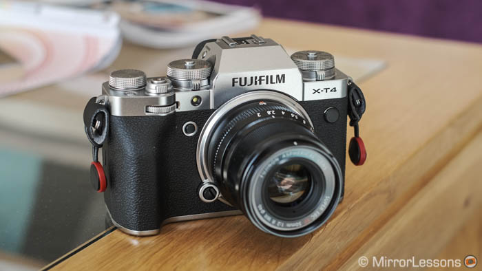 Fujifilm X-T4 with 50mm F2 attached on a wooden and glass short table