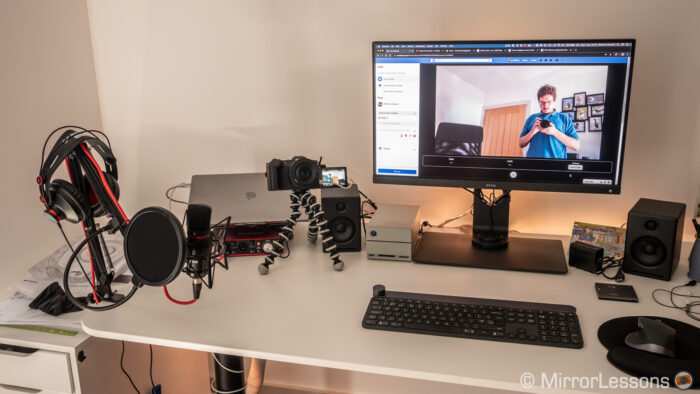 desk with laptop, screen and camera connected