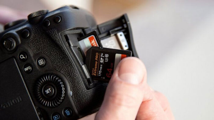 Fingers inserting a second SD card on the Canon R6