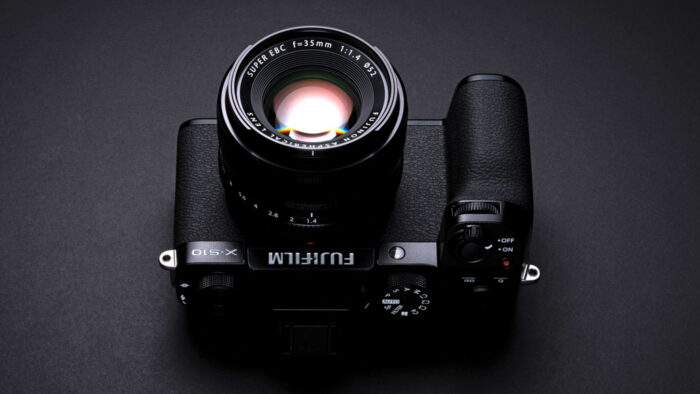 Fujifilm X-S10 with lens attached, dark background