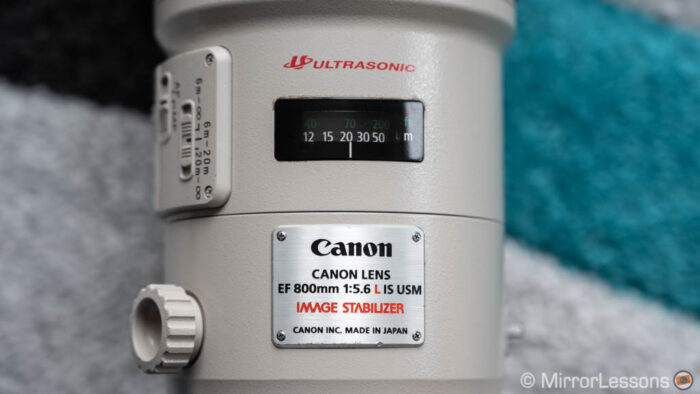 close-up of the canon 800mm showing the metallic plate with full name and focus distance indicator