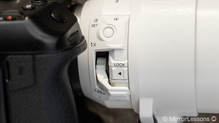 close-up on the built-in teleconverter lever and set button