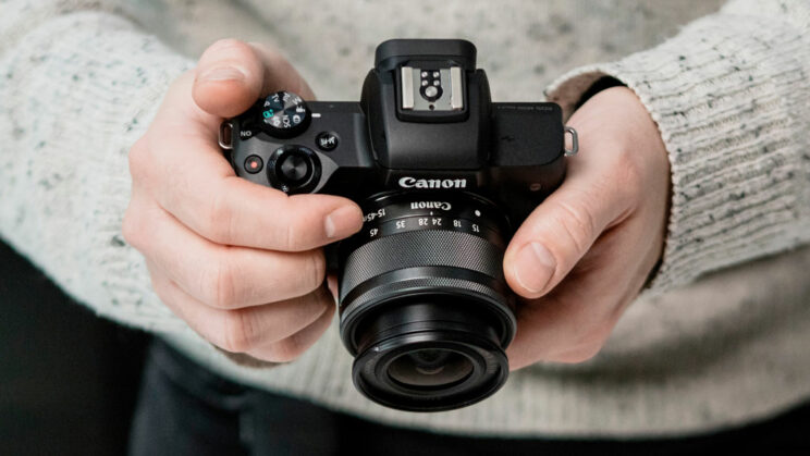 hands holding the Eos M50 II with 15-45mm kit lens attached