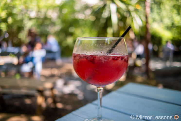 large cocktail glass in an outdoor garden bar