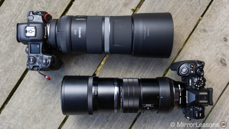 Canon R5 with 600mm F11 next to the Olympus E-M1 III and 300mm Pro, on a wooden floor