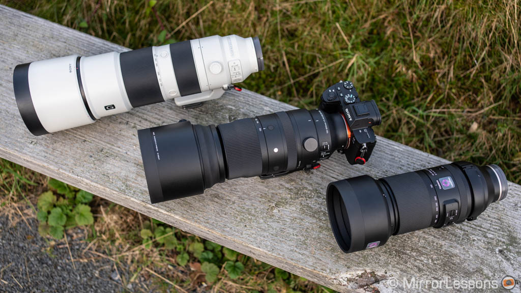 Sony 200-600mm, Sigma 150-600mm and Tamron 150-500mm side by side on a wooden bench