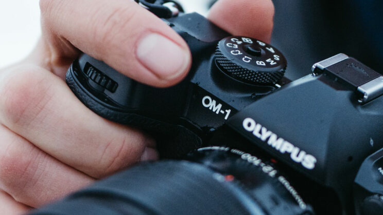close-up on hand holding the OM-1