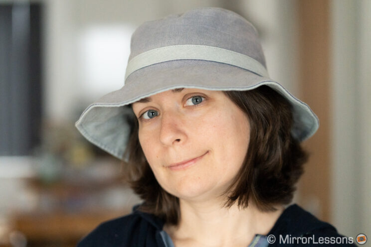 Woman wearing a hat, indoor background