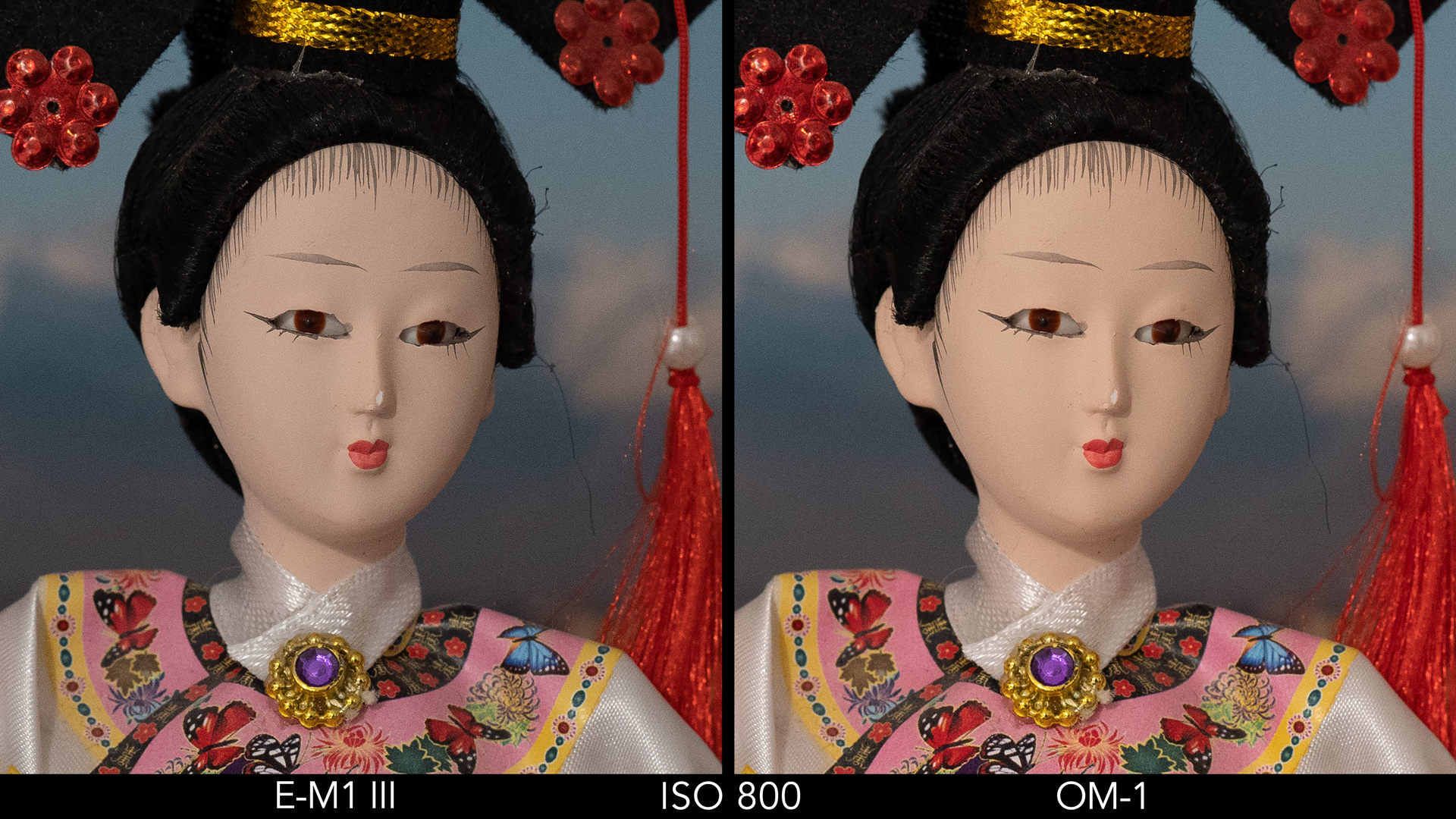 side by side image of a Japanese doll comparing ISO 800 for the E-M1 III and OM-1