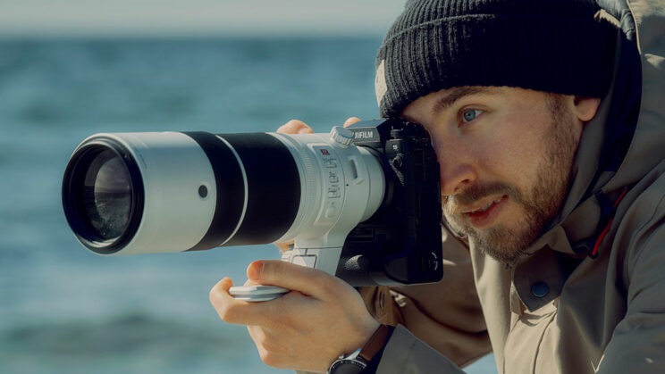 Male photographer holding the X-H2S with 150-600mm