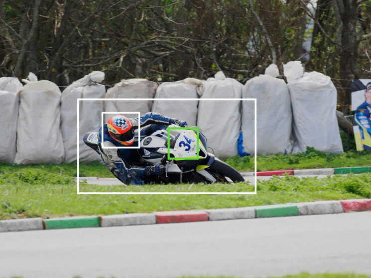Motorbike racer taking a corner, with bright and green frames showing bird detection and the Target setting