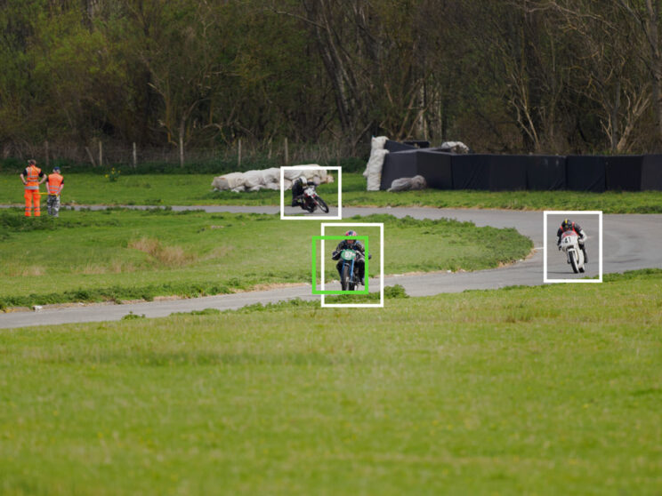 Motorbike racer on a track in the distance, with bright and green frames showing bird detection and the Target setting