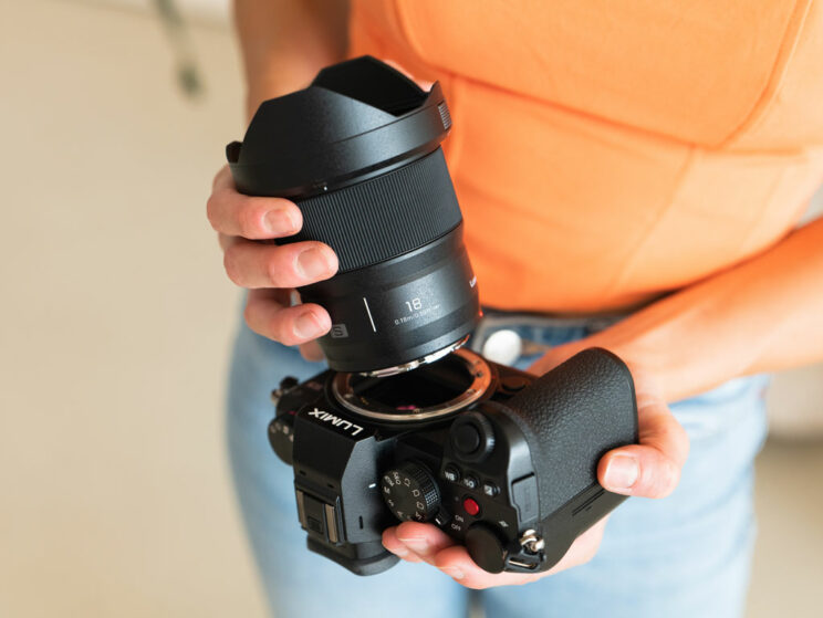 Female hands attaching the 18mm lens on the Lumix S5