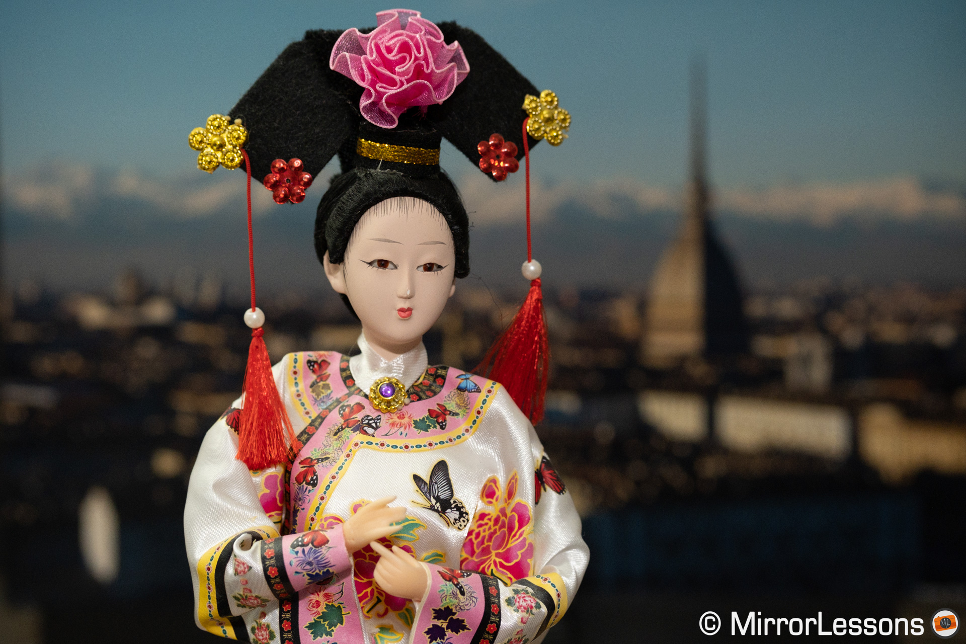 Japanese doll with a cityscape background