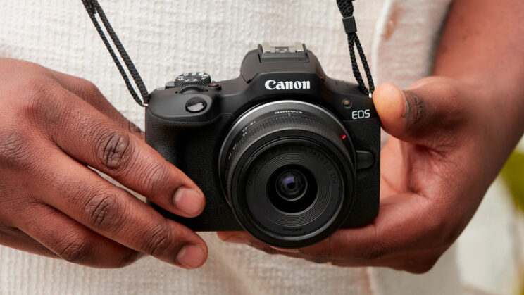 Male hands holding the Canon R100