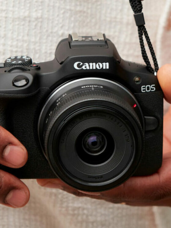 Male hands holding the Canon R100