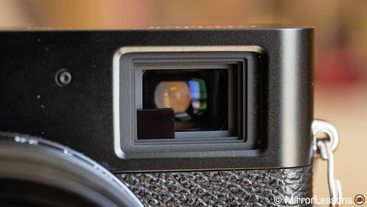 Optical viewfinder with Electronic Rangefinder on the X100V, close-up shot