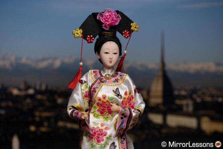 Japanese-styled doll on a urban background