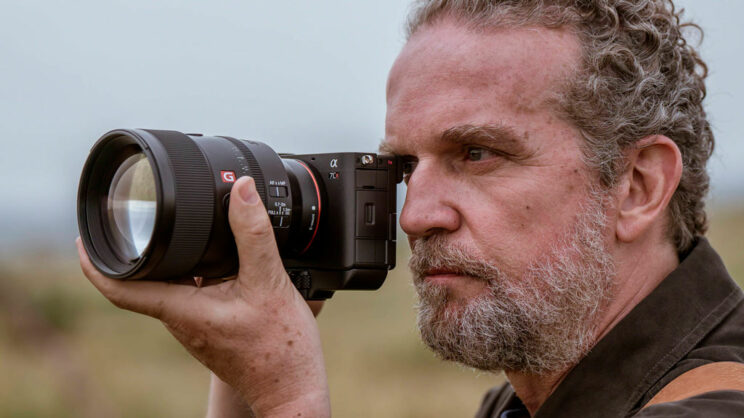 Male photographer taking pictures using the viewfinder.