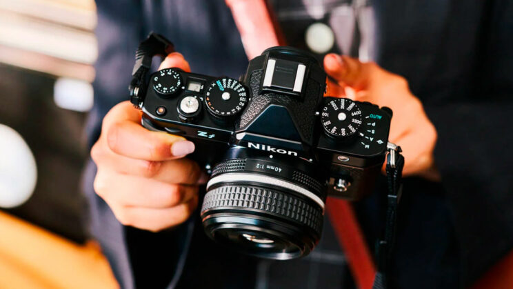 Hands holding the Nikon Zf
