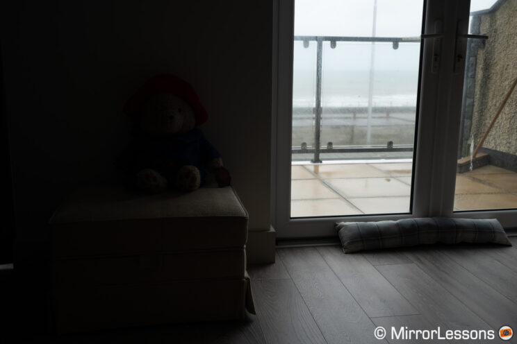Living room with large window and sea in the background