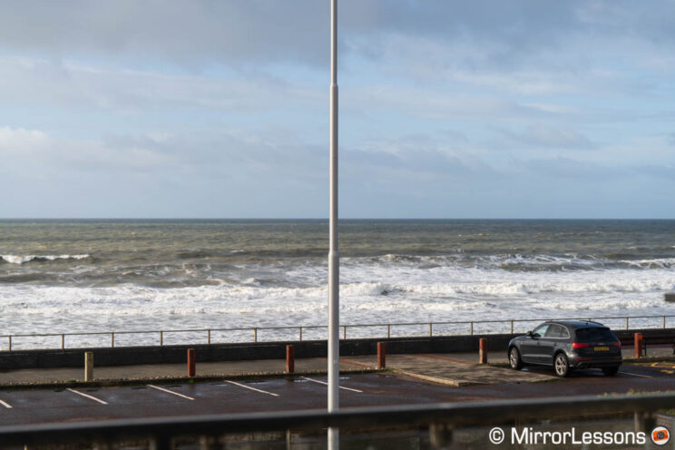 Lamppost on a promenade with sea in the background.